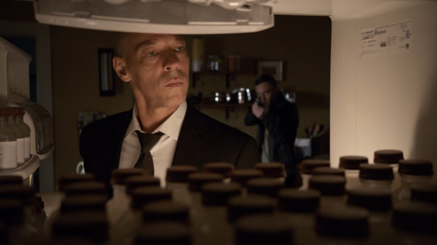 Hunter holding a gun on Enoch as seen from his refrigerator.