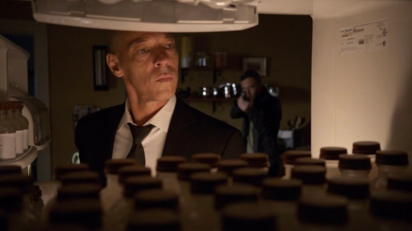 Hunter holding a gun on Enoch as seen from his refrigerator.