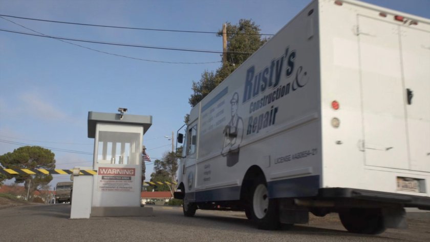 Repair truck entering military base.