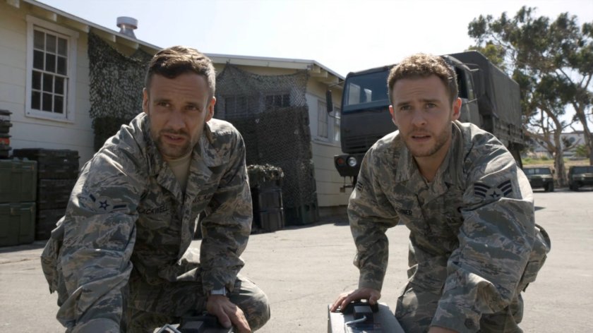 Fitz and Hunter with two metal case outside military barracks.