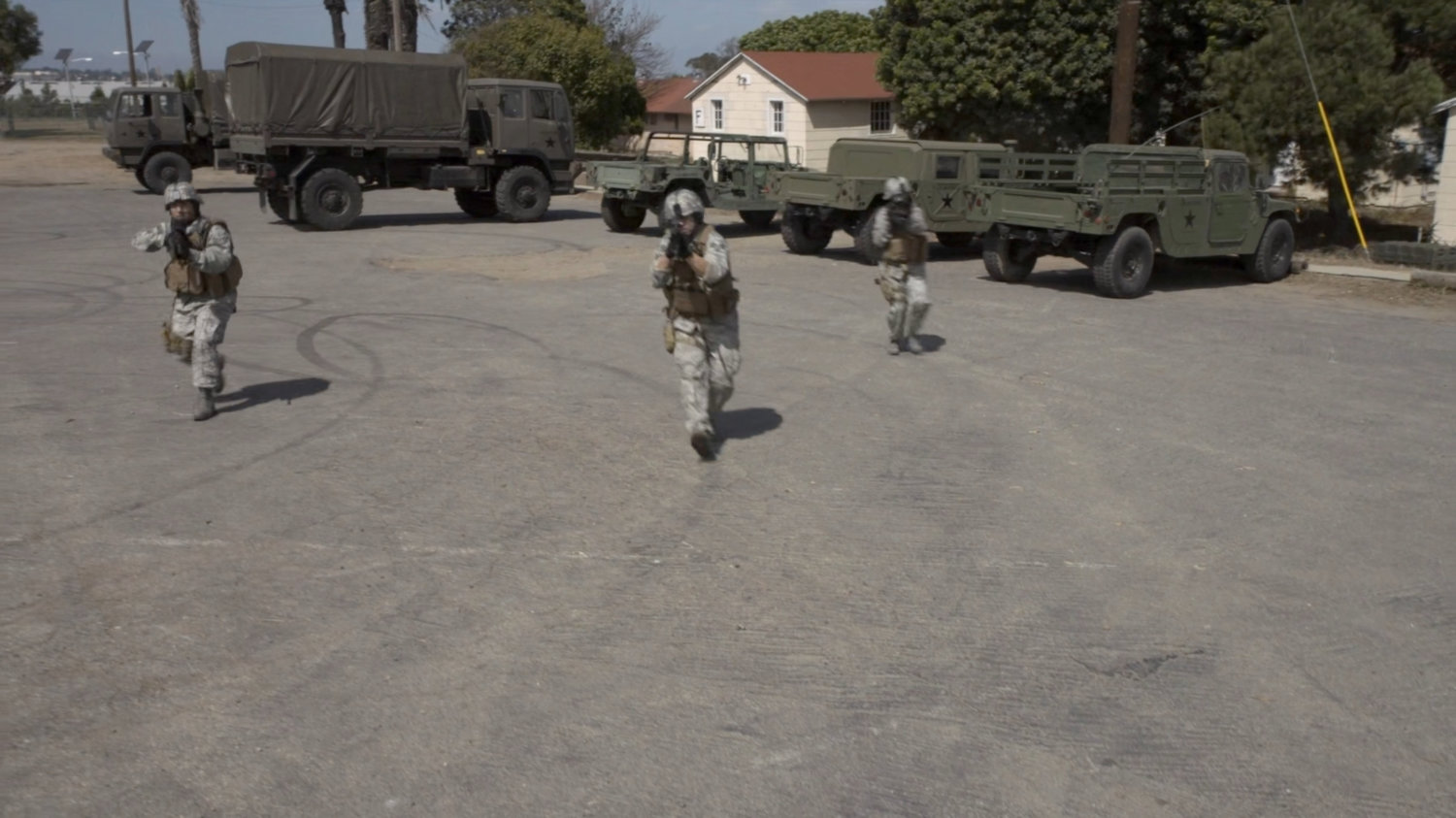 Soldiers outside a military hangar.