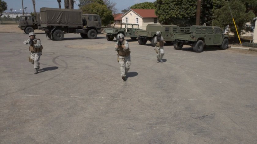 Soldiers outside a military hangar.