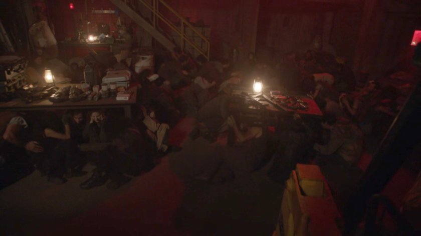 The humans gather while bombs explode, safely in Grill's Salvage Yard in the Lighthouse.