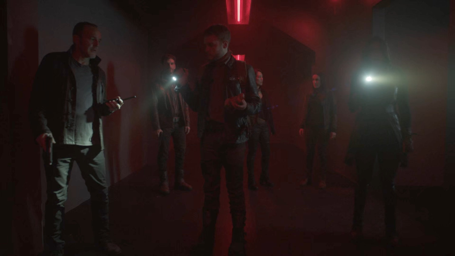 The Agents and Deke in a hallway of the Lighthouse.