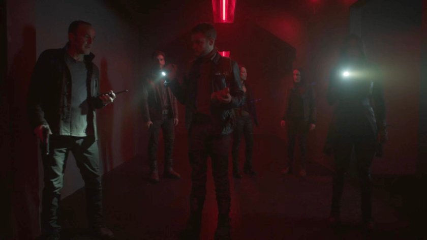 The Agents and Deke in a hallway of the Lighthouse.