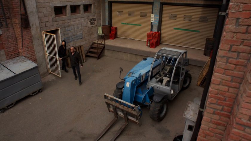 Coulson and May emerging from a gate into an alley in River's End.