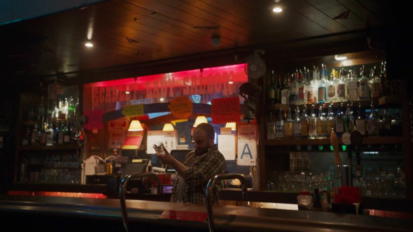 A bartender in his bar in River's End.