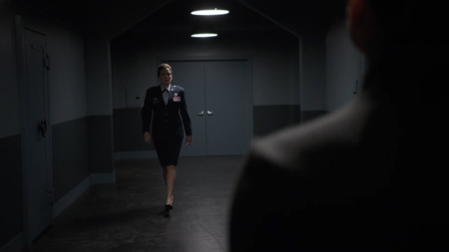 General Hale and her aide in a nondescript hallway.
