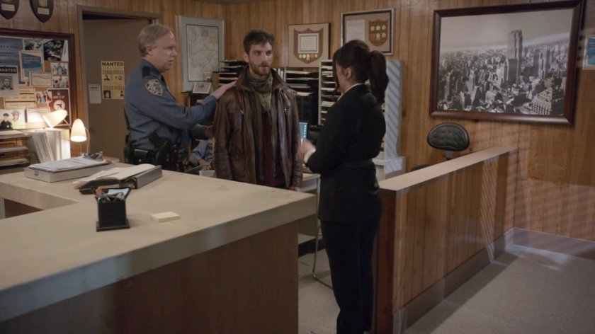 The sheriff, Daisy, and Deke inside the River's End police station.