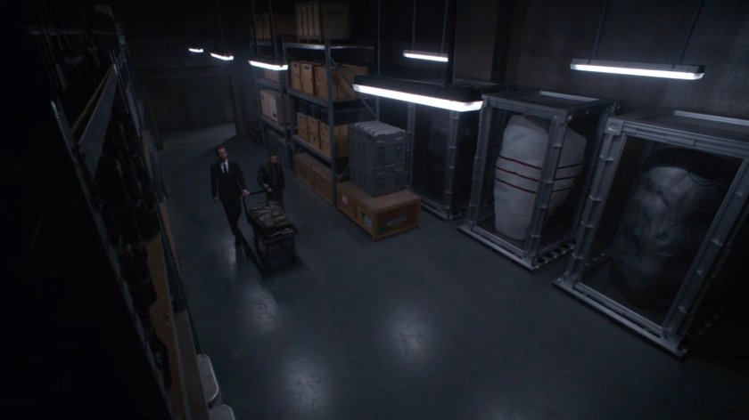 Noah and Fitz wheels a cart into the storage area of The Lighthouse.