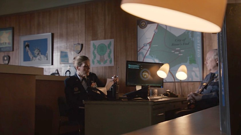 General Hale speaking to the sheriff in the police station of River's End.