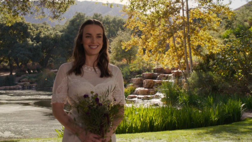 Jemma Simmons in front of a waterfall and lake on Level 27 of The Lighthouse.