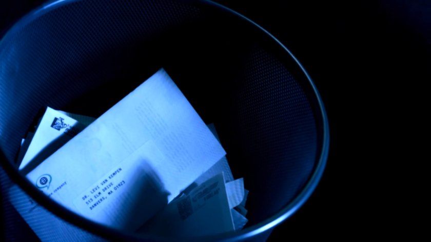 A waste basket with a letter containing Dr. Van Kempen's address.
