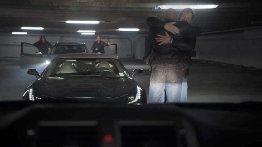 Tony and Mack hugging in a parking garage in Baton Rouge.
