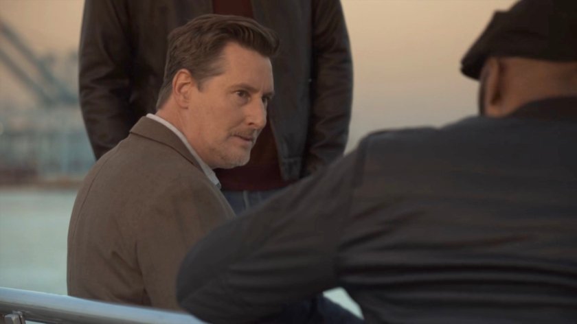 Joseph Getty with Tony and Mack on a bench overlooking a harbor.
