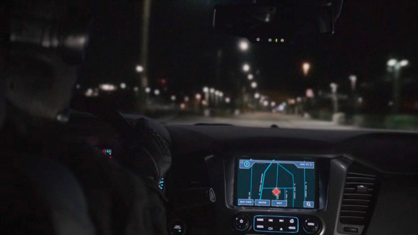 View of car dashboard and road at night.
