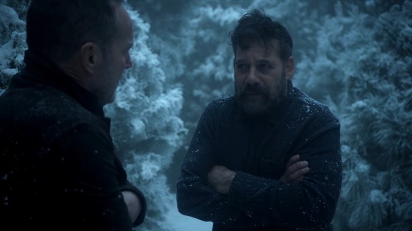 Coulson and Talbot in a snowy pine forest.