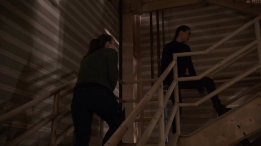 Simmons and Yo-Yo sneaking up stairs in a HYDRA R&D site in Hereforshire.