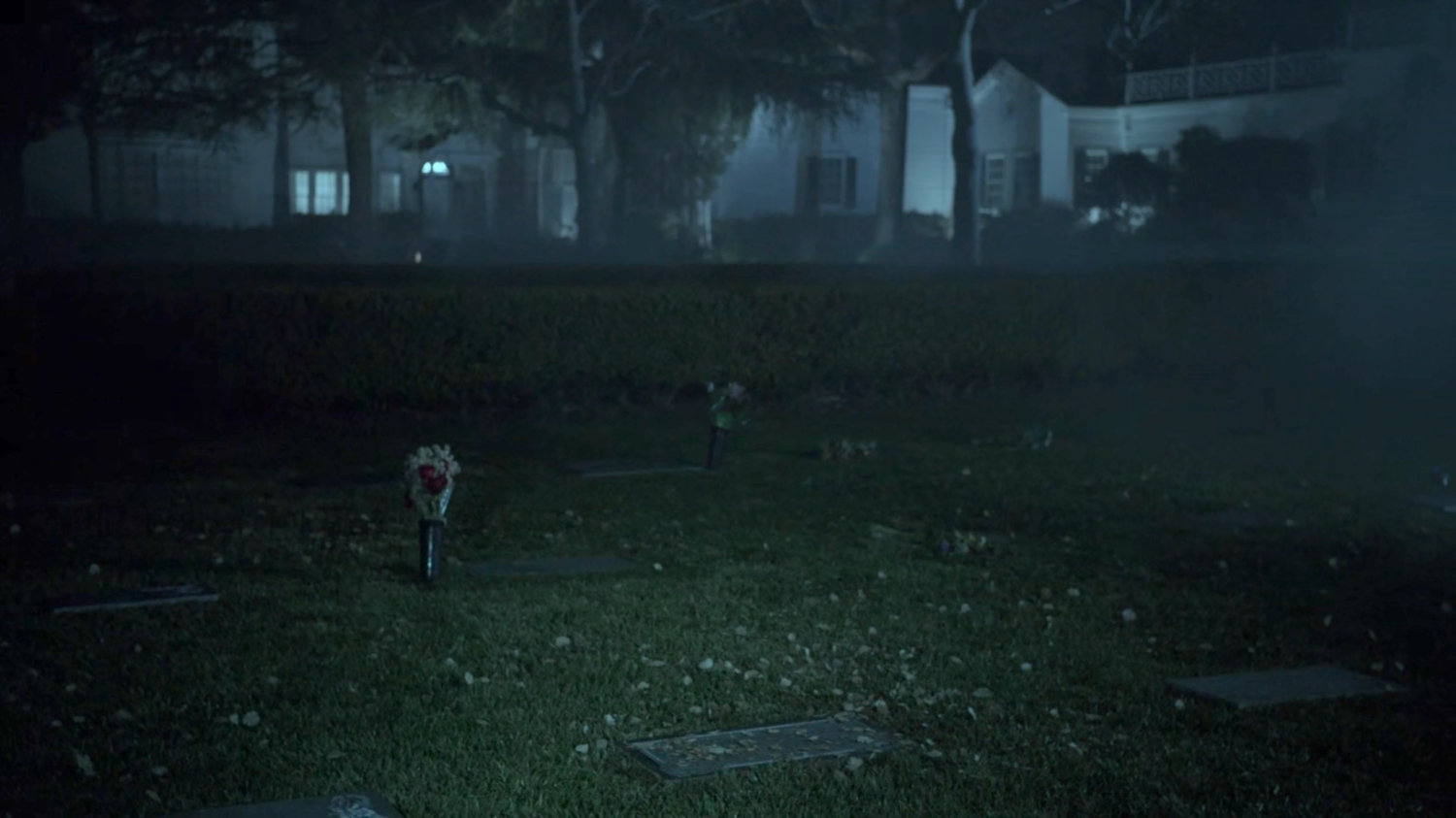 Foggy cemetery at nighttime.