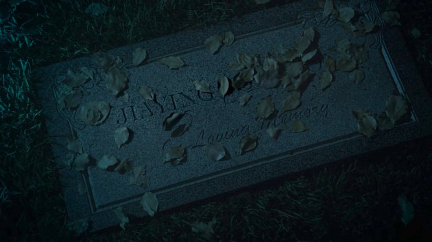 Closeup of Jiaying's grave marker in a foggy cemetery at nighttime.