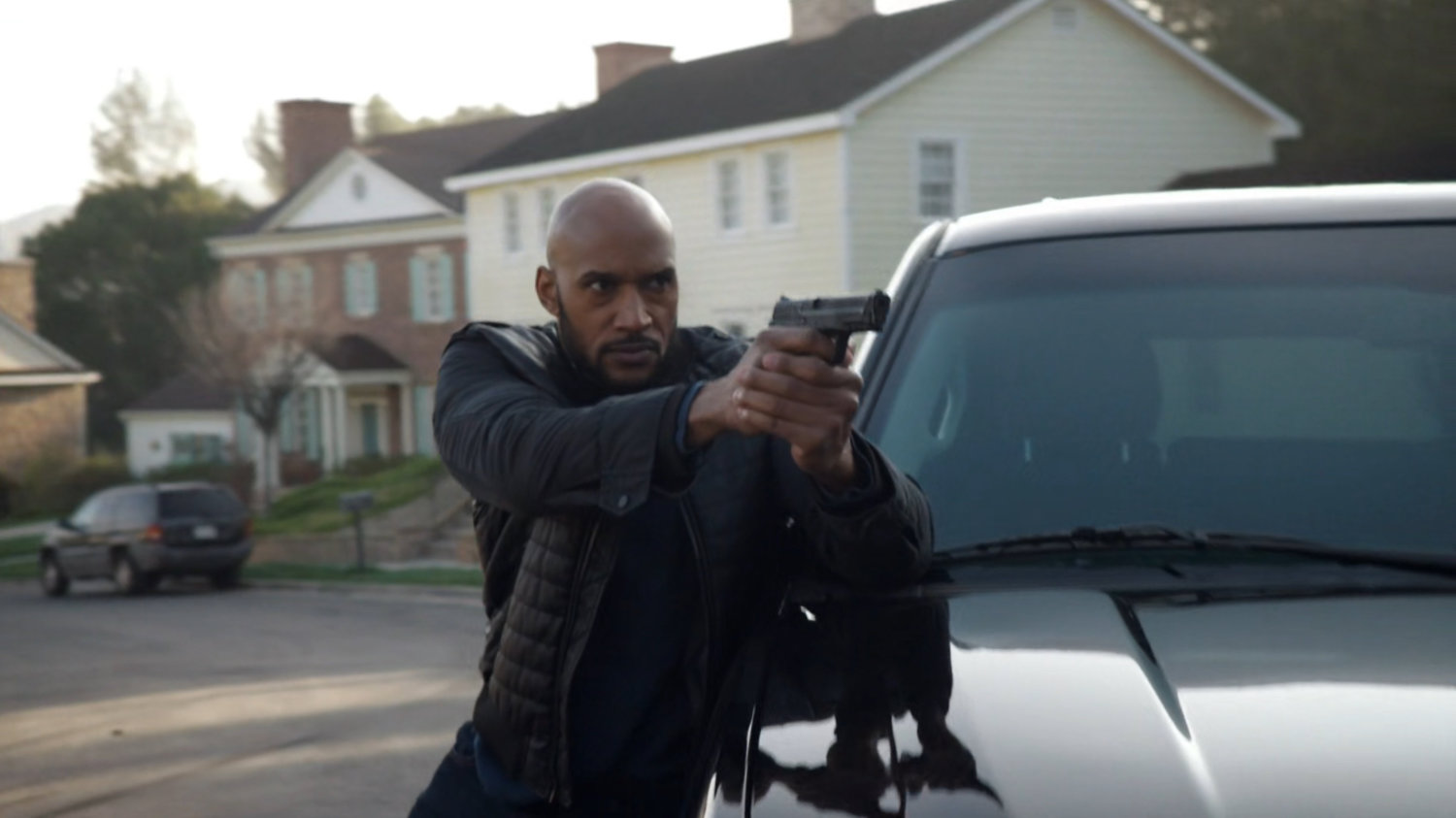 Mack with gun drawn outside the Talbot house.