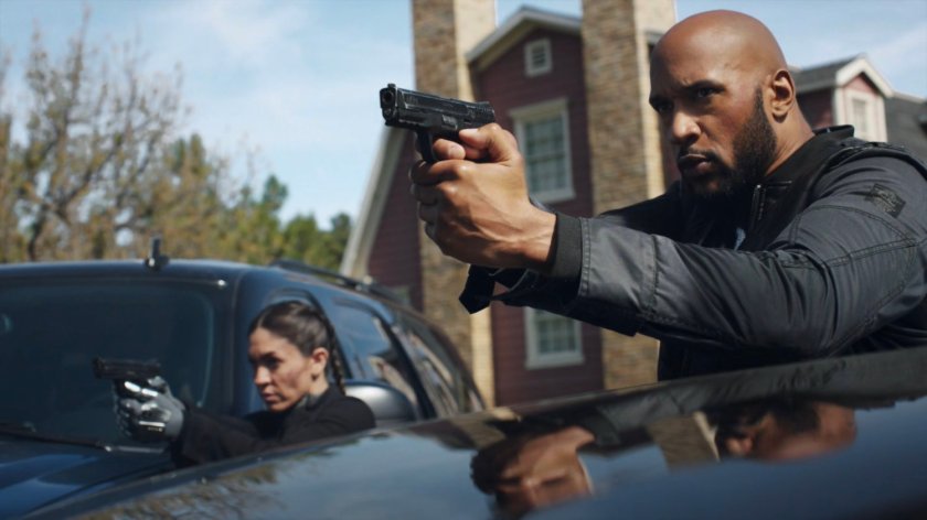 Mack and Yo-Yo with guns drawn outside the Talbot house.