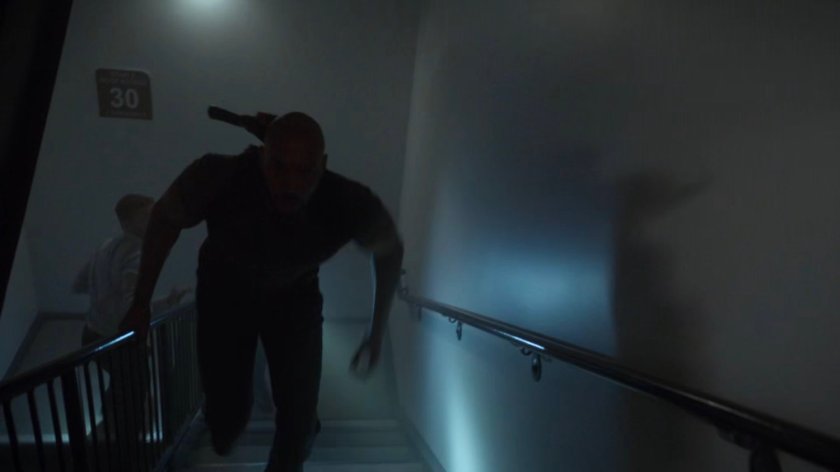 Mack and Fitz run up stairs in a Chicago high rise.