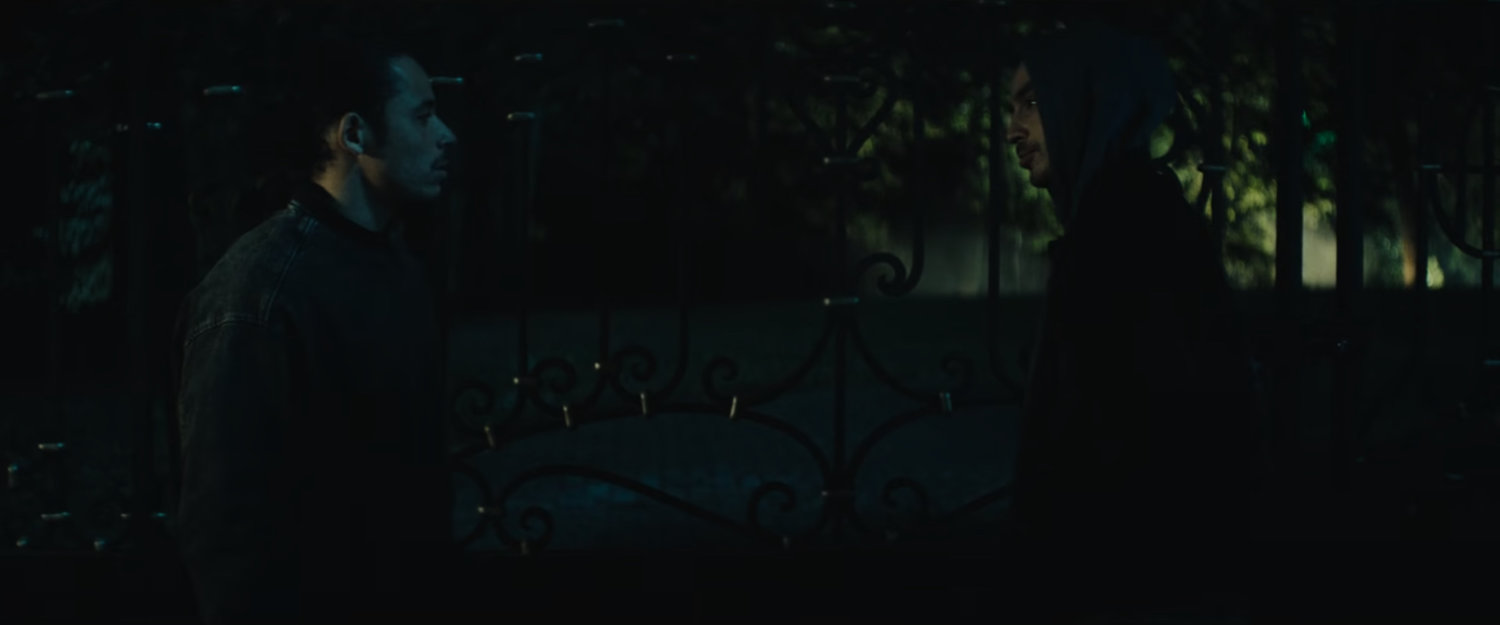 The Hood outside of a fancy mansion at night.