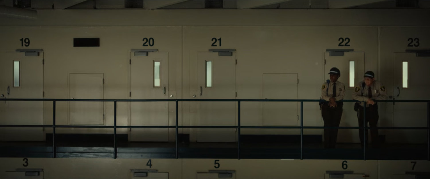 Two guards on a balcony at the Cook County Jail.