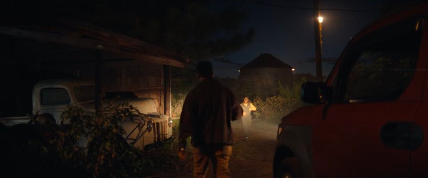 Delivery driver approaching Riri outside Joe's bunker.