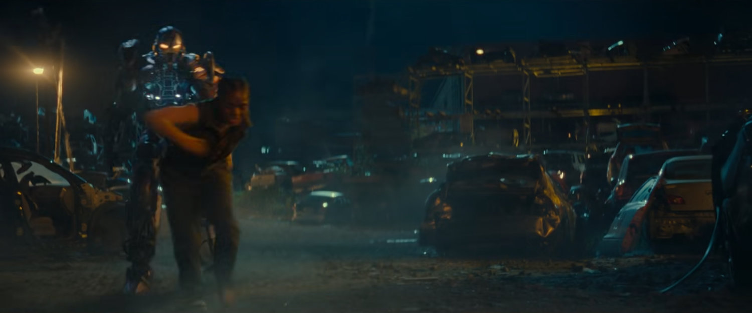Riri getting out of armor in a junkyard.