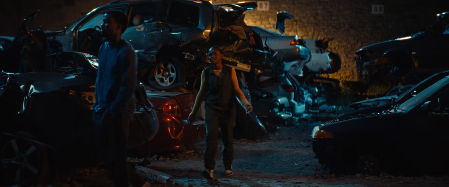 Xavier and Riri in a junkyard.