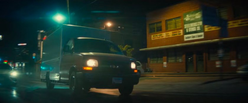 A van driving along a street outside White Castle.