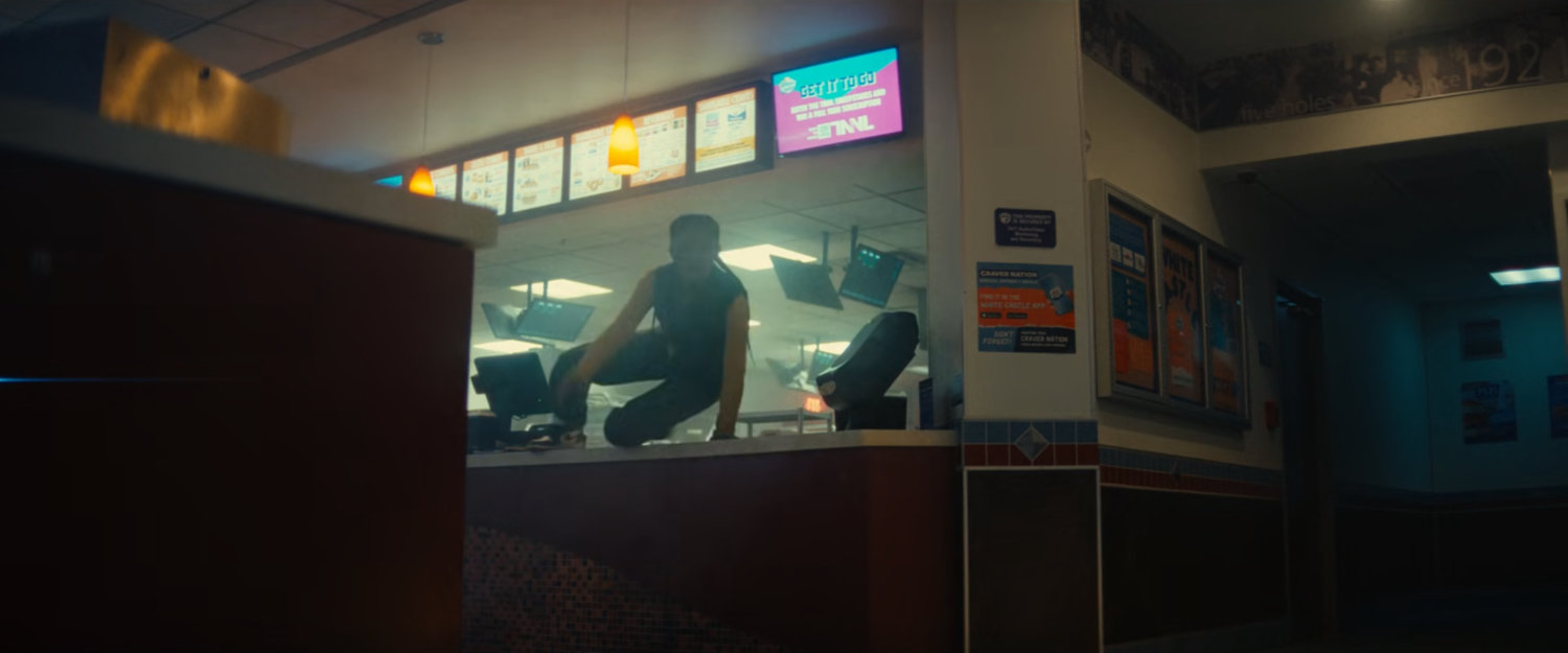 Riri leaping over a counter inside White Castle.