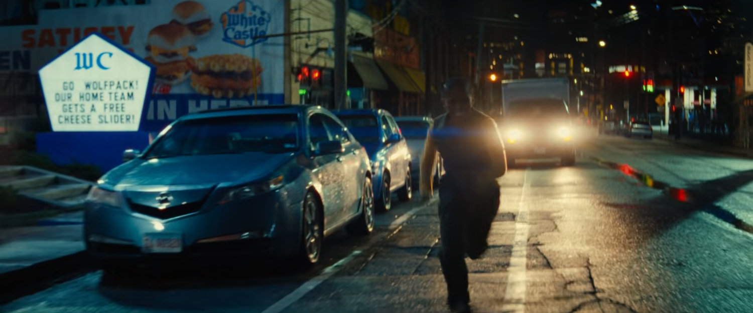 Riri running along street followed by Van outside White Castle.