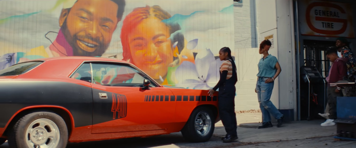 Riri and Ronnie outside Gary's Auto Repair with a 1971 Plymouth 'Cuda.