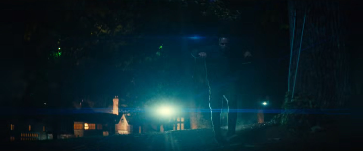 Parker runs from guards outside a fancy mansion.