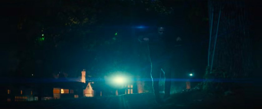 Parker runs from guards outside a fancy mansion.