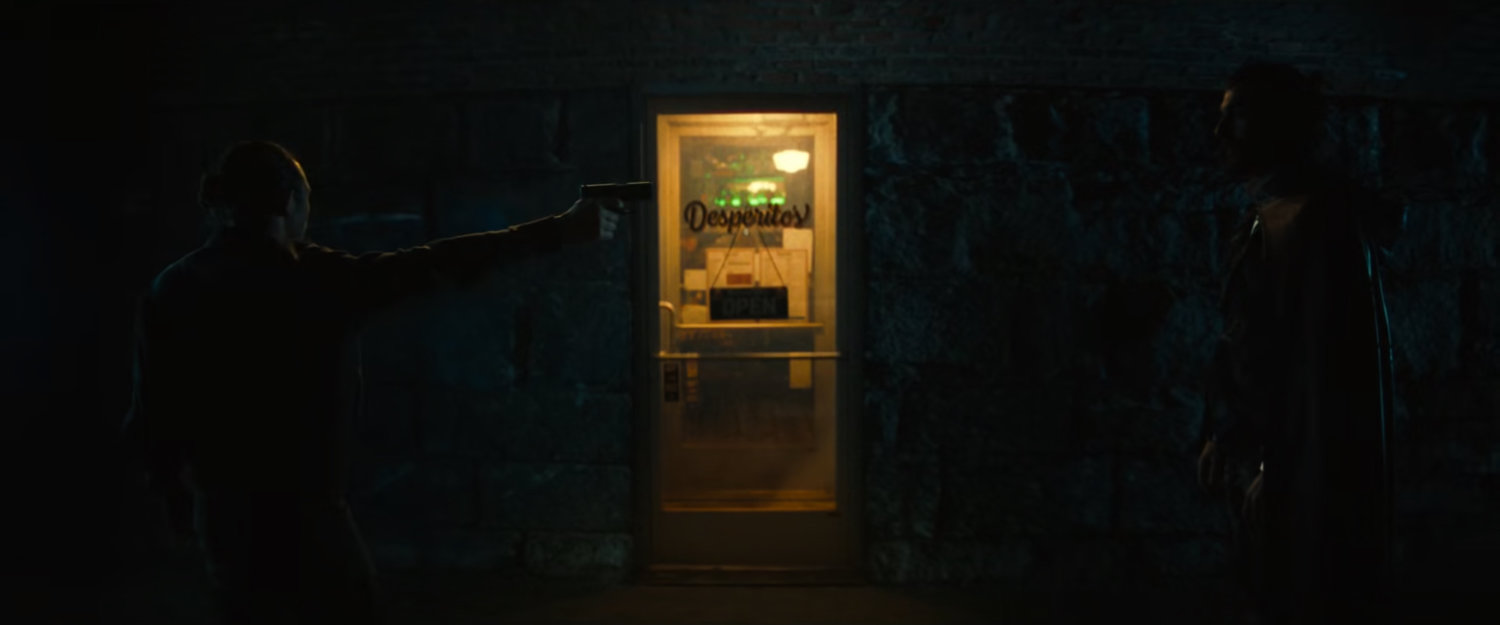 Parker and Mephisto in an eerie tunnel with an entrance to Desperito's Pizza.