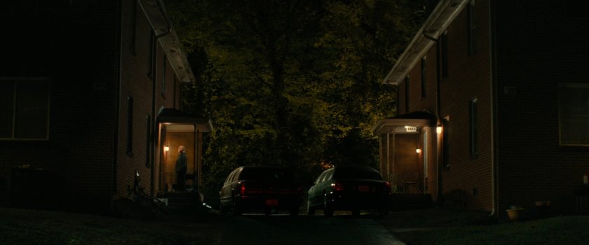 Yelena outside Alexei's house at night.