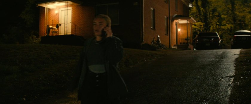 Yelena outside Alexei's house at night.