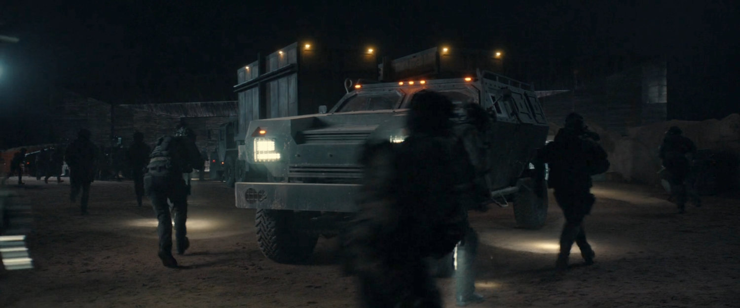 Soldiers stopping a truck in the OXE Vault courtyard.
