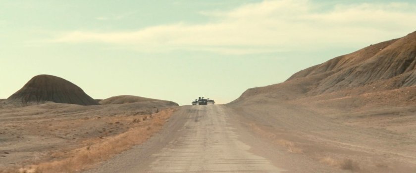 Three APCs driving across the desert of Utah.
