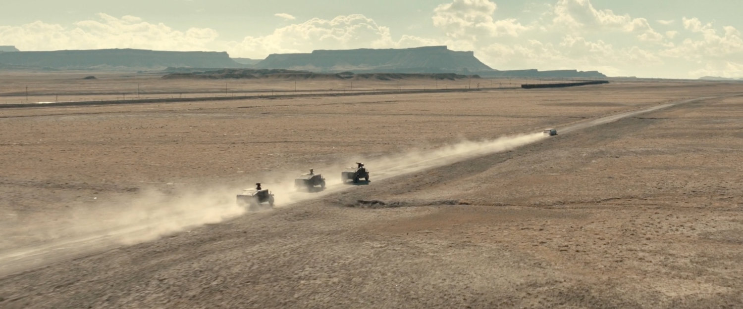 Three APCs chasing a limo across the desert of Utah.