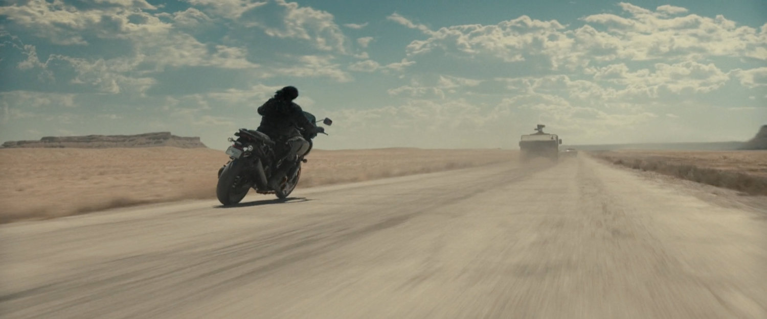 Bucky following an APC in the desert of Utah.