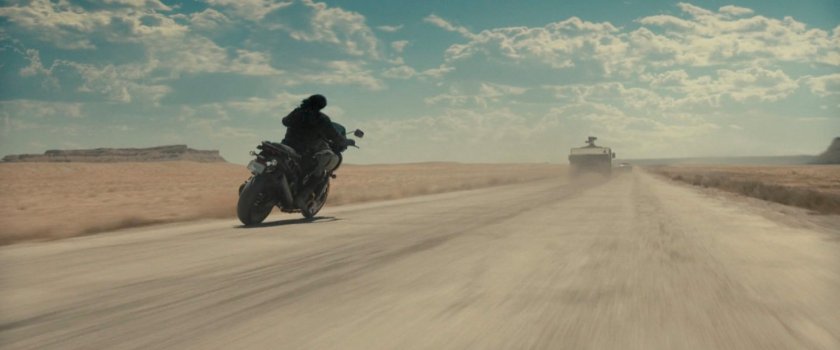 Bucky following an APC in the desert of Utah.
