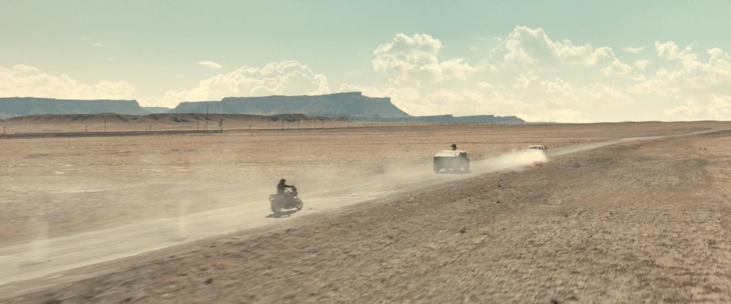 Bucky following an APC in the desert of Utah.