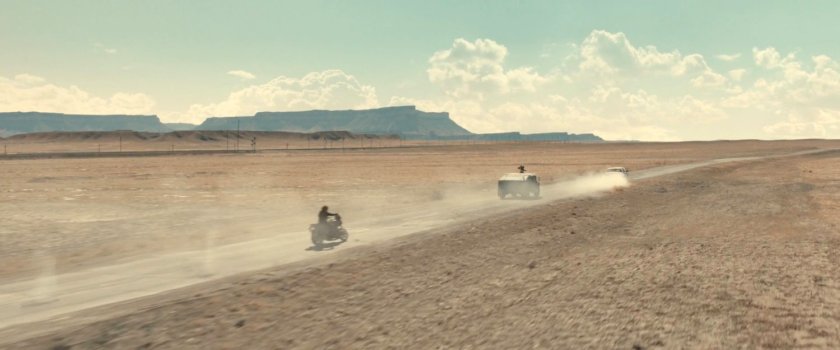Bucky following an APC in the desert of Utah.