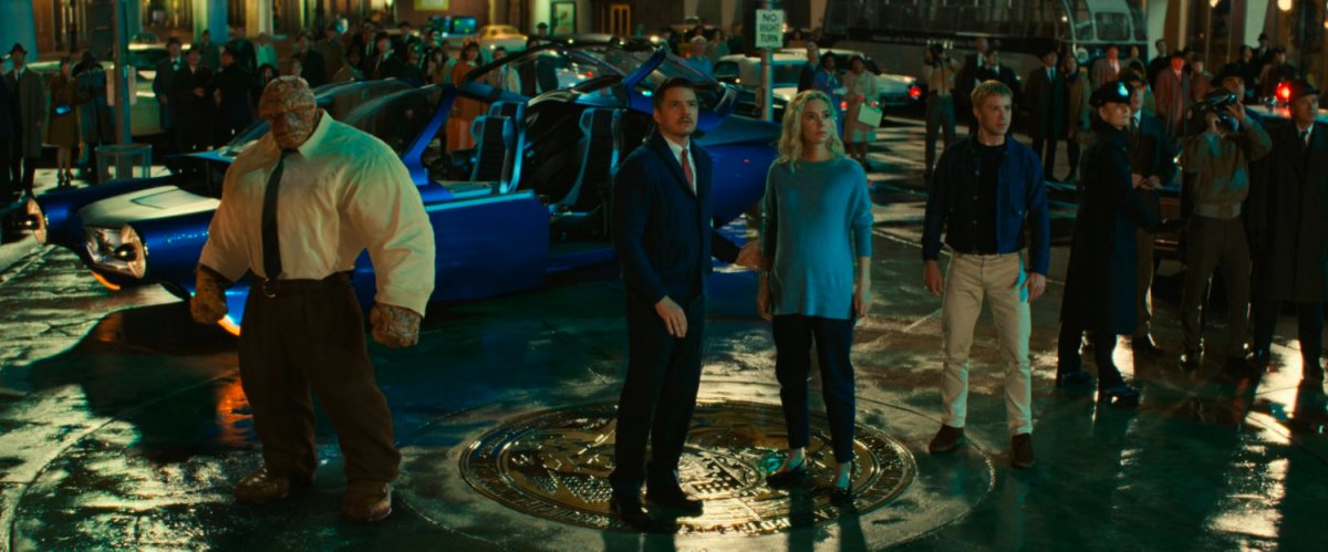 Ben, Reed, Sue and Johnny stand in the middle of Times Square at night.