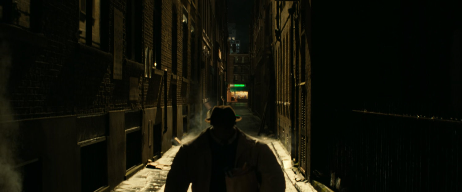 Ben walking along a dark New York Alley.